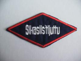 Sikasiistijuttu -   hihamerkki