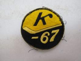 Kiekko -67 -kangasmerkki / badge