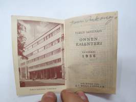 Turun Sanomain onnenkalenteri 1936, kannessa olympiarenkaat, sisäkansissa toimitalokuvat -calendar