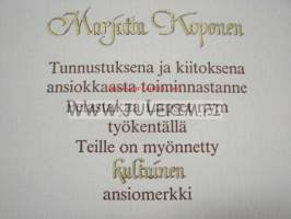 Pelastakaa Lapset ry kultainen ansiomerkki Marjatta Koponen 1984 -myöntökirja