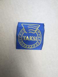 Taksi -kangasmerkki, pukuun / takkiin tarkoitettu ammattikuljettajan merkki