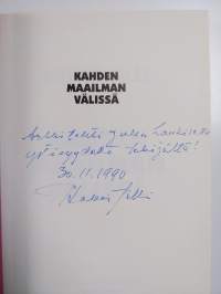 Kahden maailman välissä (signeerattu, tekijän omiste)