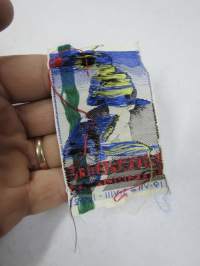 XV Olympiaden Helsingfors -kangasmerkki, merkissä kuvattuna Paavo Nurmi