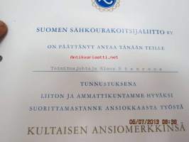 Suomen Sähköurakoitsijaliitto ry 1973 / Klaus Stenroos / Kultainen ansiomerkki -myöntökirja